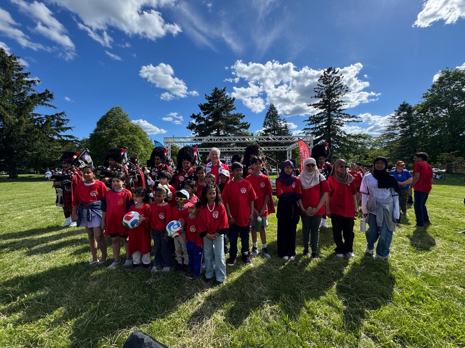 Wide group photo of families and performers at FIFA Fan Fest 2026